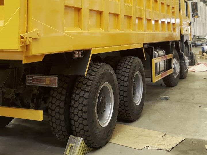 Four axles of a yellow SHACMAN F3000 8×4 dump truck in the Ant Trucks workshop