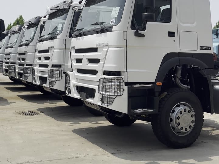 Row of white Sinotruk HOWO 371 tractor heads in the Ant Trucks yard, Jiaxiang